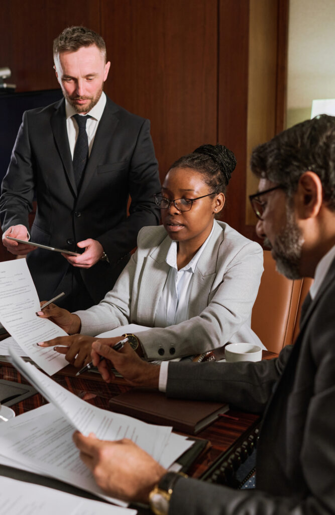 Smiling immigration lawyer in Bucks County providing legal consultation. A professional attorney discussing citizenship and naturalization processes with a client in an office setting.